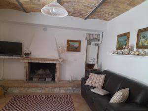 a living room with a couch and a fireplace at Gabriella in SantʼEufemia a Maiella