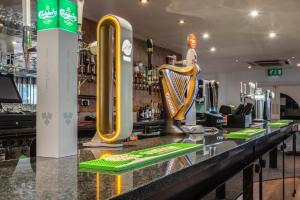 a bar with a yellow and black counter top at Best Western The Plough Hotel in Northampton