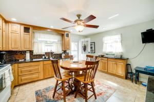 a kitchen with a table and chairs and a ceiling fan at Shadyside House - 100 feet to Walnut Street! in Pittsburgh