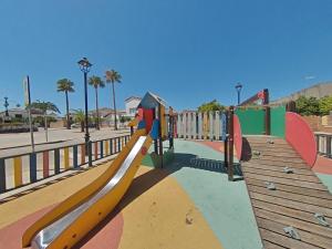 a playground with a slide in a park at CASA ROSAL in Cañada Rosal