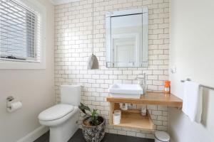 a white bathroom with a sink and a toilet at Sofia Rose House and Cottage in Katoomba +15 photos