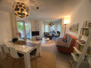 a living room with a table and a couch at Pool & Lake Holiday Home in Markkleeberg