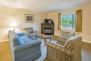 a living room with a couch and chairs and a fireplace at Massanuttens Shenandoah Villas by TripForth in McGaheysville