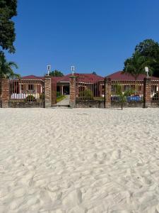 - un bâtiment sur la plage à côté d'une plage de sable dans l'établissement KAWETA COTTAGE, à Yadinga