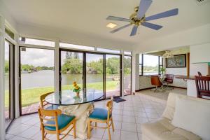 a living room with a glass table and chairs at Cocoa Beach House on Banana River Walk to Ocean! in Cocoa Beach