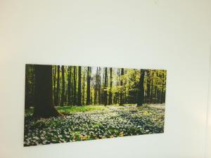 a painting of a forest with leaves on the ground at Enjoy Modern Living and Free WiFi in Kingston Newport 2 Bedroom Apartment in Newport