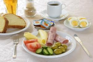 a table with two plates of food with eggs and bread at Amalia in Paleo Tsifliki