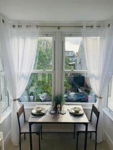 a table and chairs in front of a window at Willow’s Place in Leigh-on-Sea