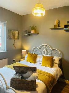 a bedroom with a large bed with yellow pillows at Willow’s Place in Leigh-on-Sea