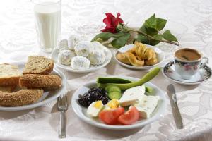 a table with plates of food and a cup of coffee at Amalia in Paleo Tsifliki