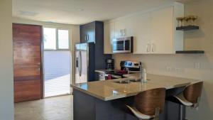 a kitchen with a counter and some chairs in it at Islas Del Mar, Eagle Village B9 in Puerto Peñasco