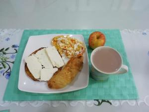 einen Teller mit Brot und Käse und eine Tasse Kaffee in der Unterkunft ALAMEDA MI DESCANSO in Carmen de Viboral