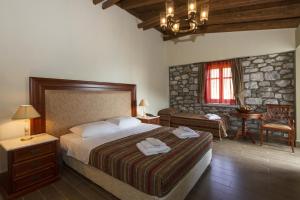 Rúm í herbergi á Itilo Traditional Hotel