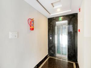 a hallway with a fire extinguisher on the wall at White Ridge in Surūrnagar