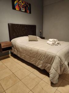 a bedroom with a large bed with a head board at At Home CdelU in Concepción del Uruguay