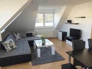 a living room with a couch and a table at Ferienwohnung Alte Räucherei DH-60114 in Lubmin