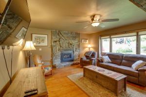 a living room with a couch and a fireplace at Cozy Lead Cabin with Deck Less Than 1 Mi to Ski Slopes! in Lead