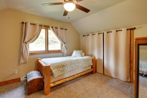 a bedroom with a bed and a window at Cozy Lead Cabin with Deck Less Than 1 Mi to Ski Slopes! in Lead