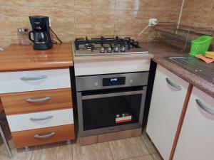 a kitchen with a stove top oven in a kitchen at BYA in Iaşi +11 photos