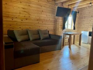 a living room with a couch and a table at Family Resort in Mostiska +37 photos