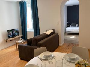 a living room with a couch and a table at Premium Appart Albi in Albi +63 photos