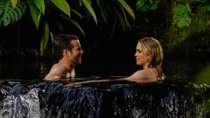 a man and woman in a hot tub in the water at Tabacón Thermal Resort & Spa in Fortuna
