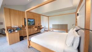 a bedroom with a bed and a desk in a room at Tabacón Thermal Resort & Spa in Fortuna