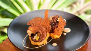 two pastries on a black plate on a table at Tabacón Thermal Resort & Spa in Fortuna
