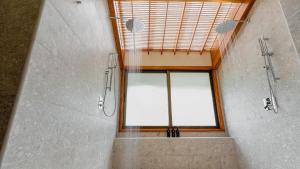a bathroom with a shower and a large window at Tabacón Thermal Resort & Spa in Fortuna