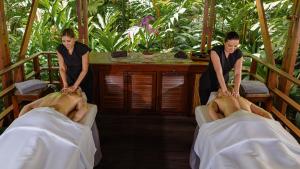 a couple of women preparing people in beds at Tabacón Thermal Resort & Spa in Fortuna