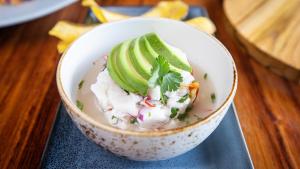 a bowl of food with cucumbers on top of it at Tabacón Thermal Resort & Spa in Fortuna