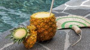 a pineapple cut in half sitting next to a pool at Tabacón Thermal Resort & Spa in Fortuna