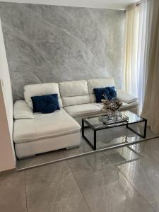 a living room with a couch and a coffee table at Neagoe residents in Birkirkara
