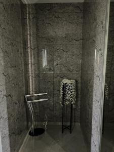 a bathroom with a glass shower with a sink at Neagoe residents in Birkirkara