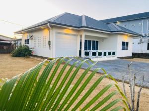 a white house with a black roof at Joy place in Landsboerderij
