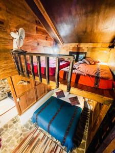 two bunk beds in a room with wooden walls at Mountain Nest in Lanquín