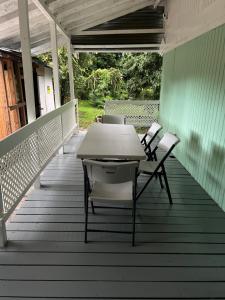 a table and chairs sitting on a deck at 3bdrm Fruit Tree Home near downtown Orlando in Orlando