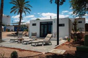 a patio with chairs and a table and a building at Casa Bahia in La Paz