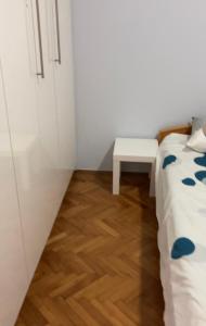 a small room with a bed and a table at St. Sava Slavija Apartment in Belgrade
