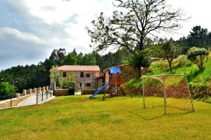 a playground with a swing set in a yard at Casa Faustino in A Coruña