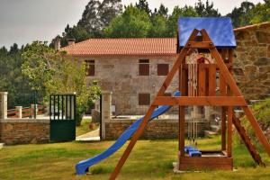 a playground with a slide in a yard at Casa Faustino in A Coruña