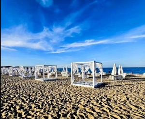a row of chairs and umbrellas on a beach at Sopot Marina Beach Suites in Sopot