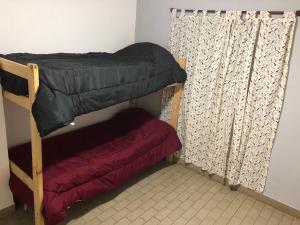 a room with two bunk beds and a curtain at Departamento 4 dormitorio in Corrientes
