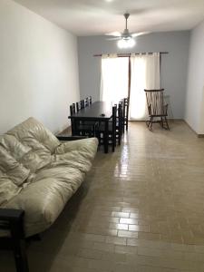 a living room with a couch and a table and chairs at Departamento 4 dormitorio in Corrientes