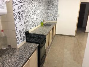 a kitchen with a stove and a counter top at Departamento 4 dormitorio in Corrientes +2 photos