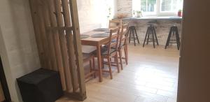 a kitchen with a wooden table and chairs in a room at Dailidžių apartamentai in Klaipėda +18 photos