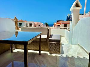 a table on a balcony with a view of the ocean at Luxury Diamond - Ocean view, Big terraces, Air Con, Wifi in Los Cristianos