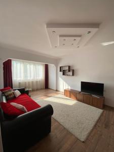 a living room with a couch and a flat screen tv at 514 DISTRICT in Hunedoara