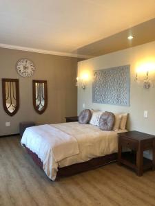 a bedroom with a large bed with two pillows on it at The Water Wheel in Vryheid