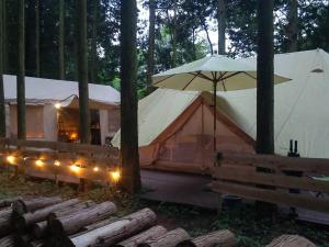 a couple of tents in the woods with lights at Minamiaso STAYHAPPY - Vacation STAY 28451v in Shimoda